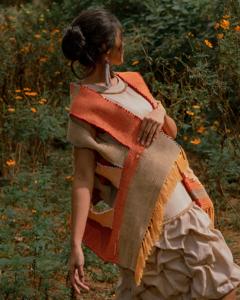 a woman wearing an orange BAYO atalier local handcrafted garment