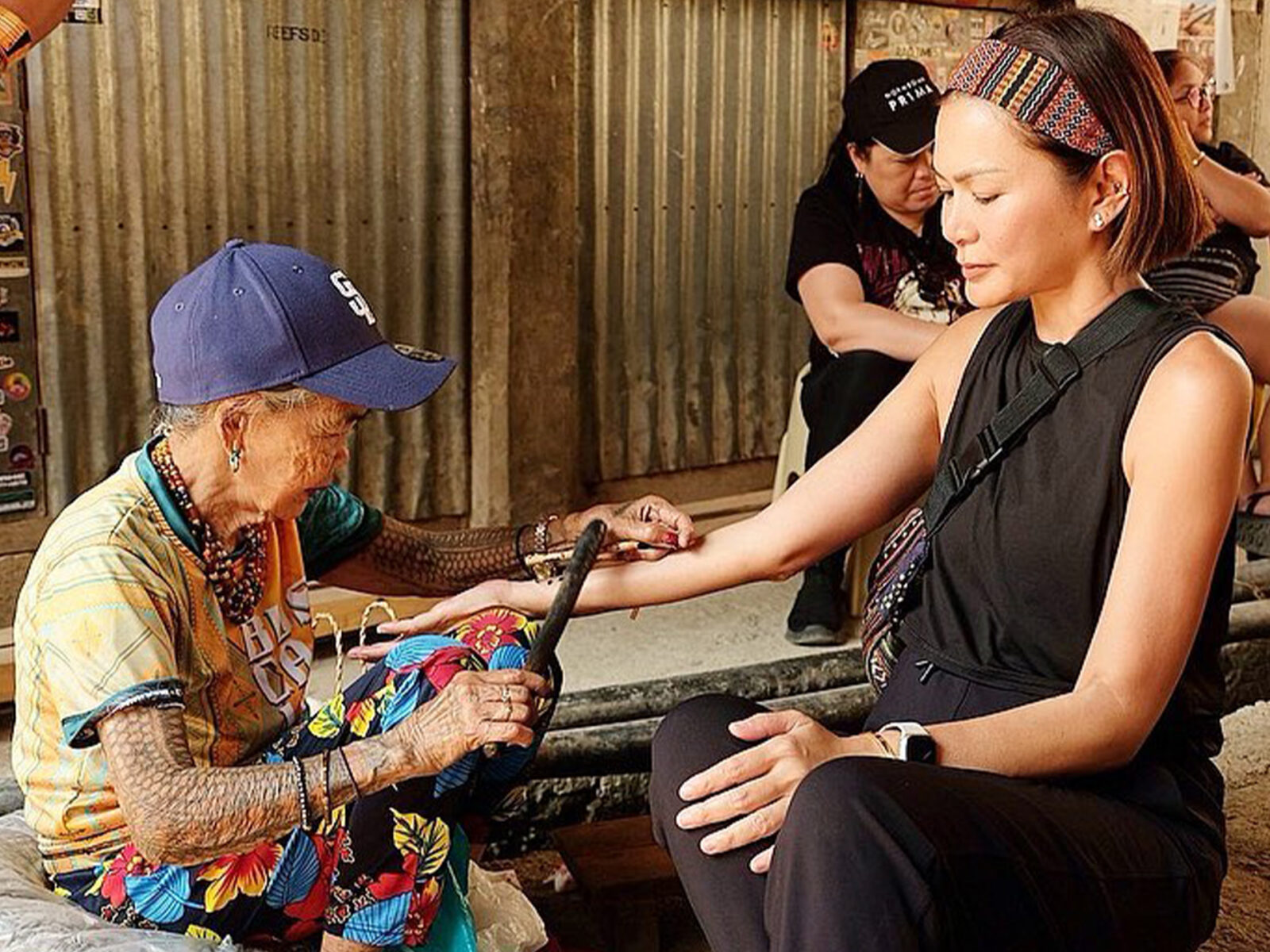 Apples Aberin getting a tattoo on her wrist from Apo Whang-Od