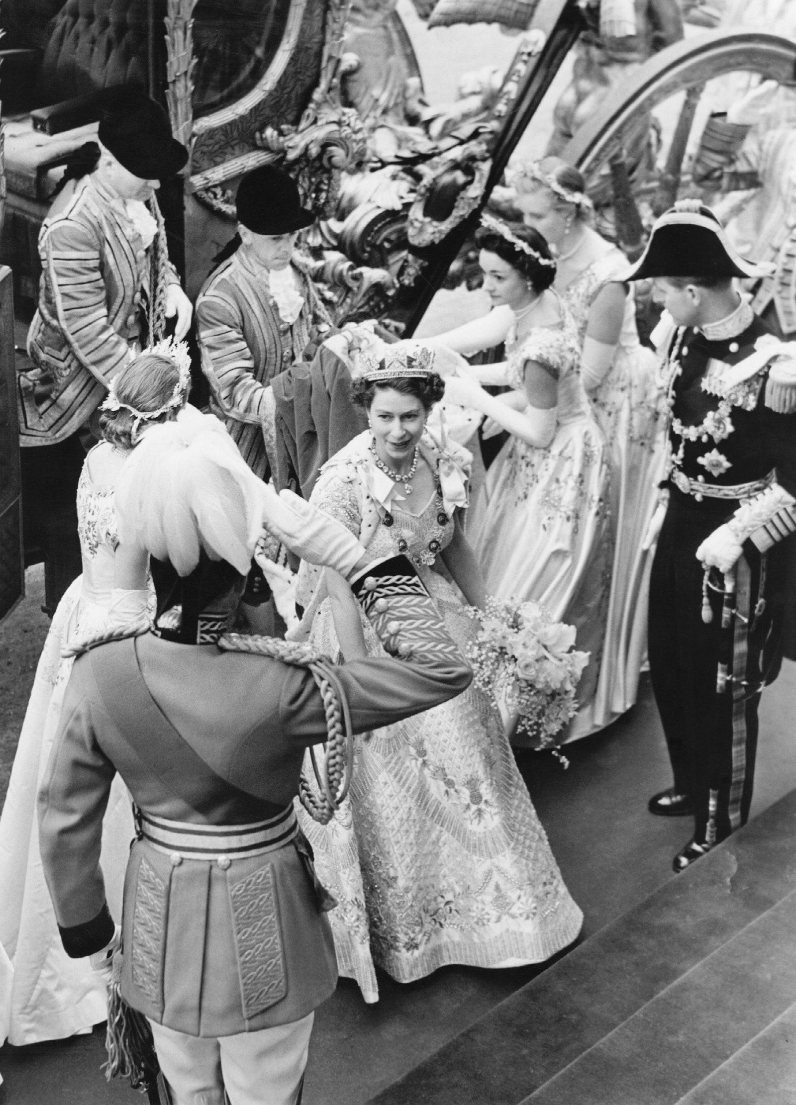 The Queen arriving at her Coronation with her attendants in Hartnell’s silk flower creations.