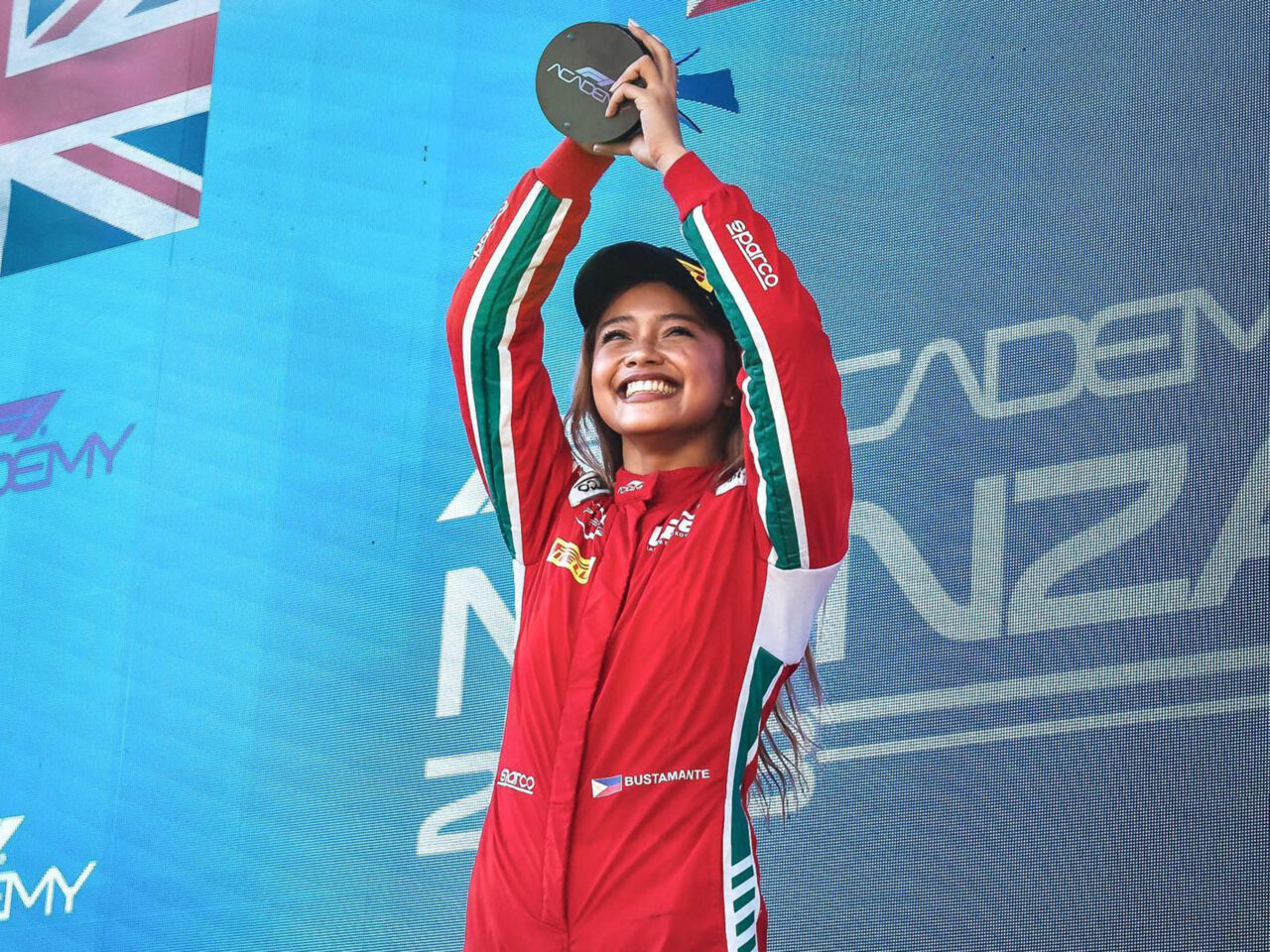 Bianca Bustamante lifts her award at the podium in Monza, Italy