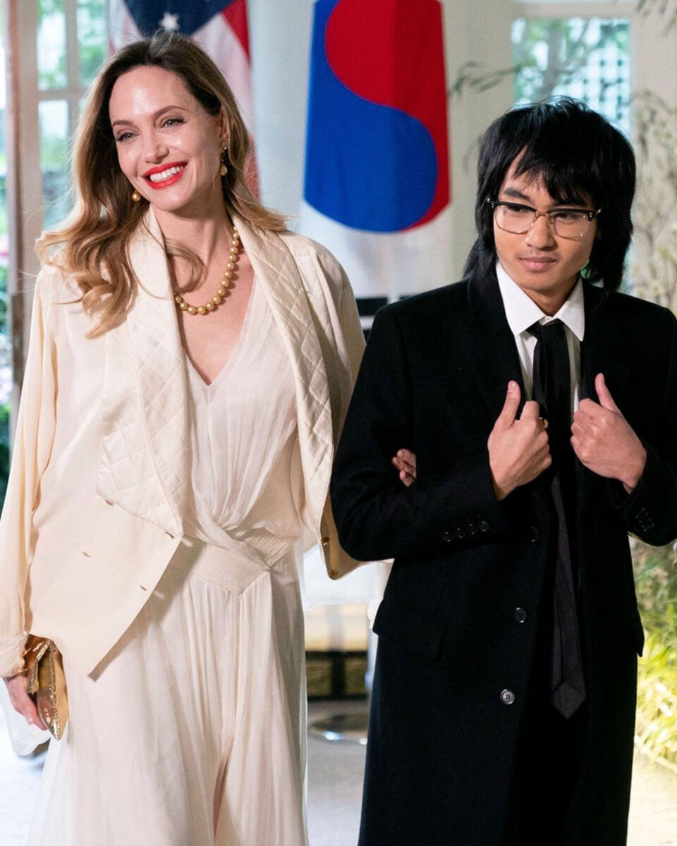 Angelina Jolie in beige Chanel jacket with her son Maddox
