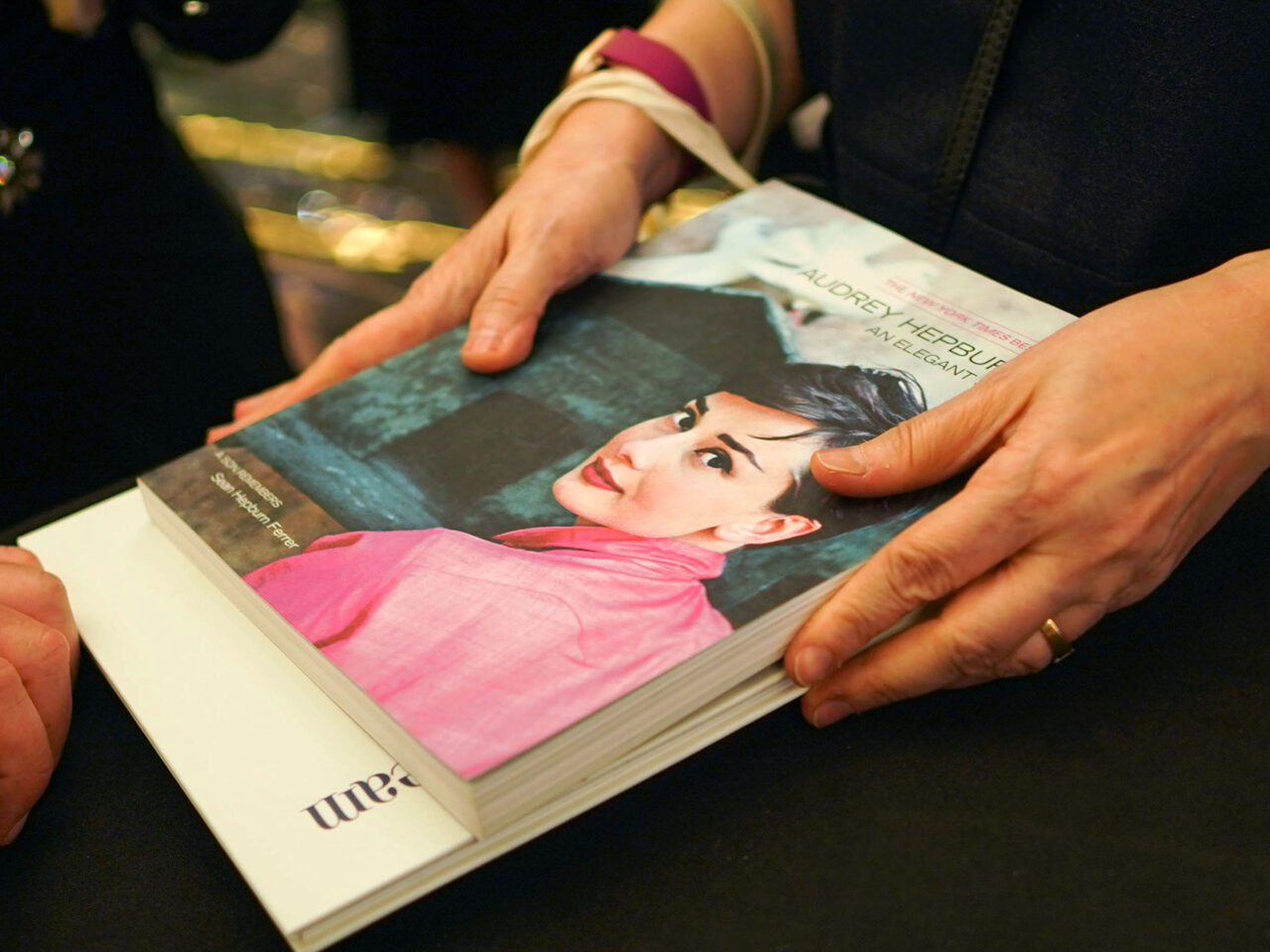 A person holding a book of Audrey Hepburn during the Intimate Audrey Exhibit in Manila