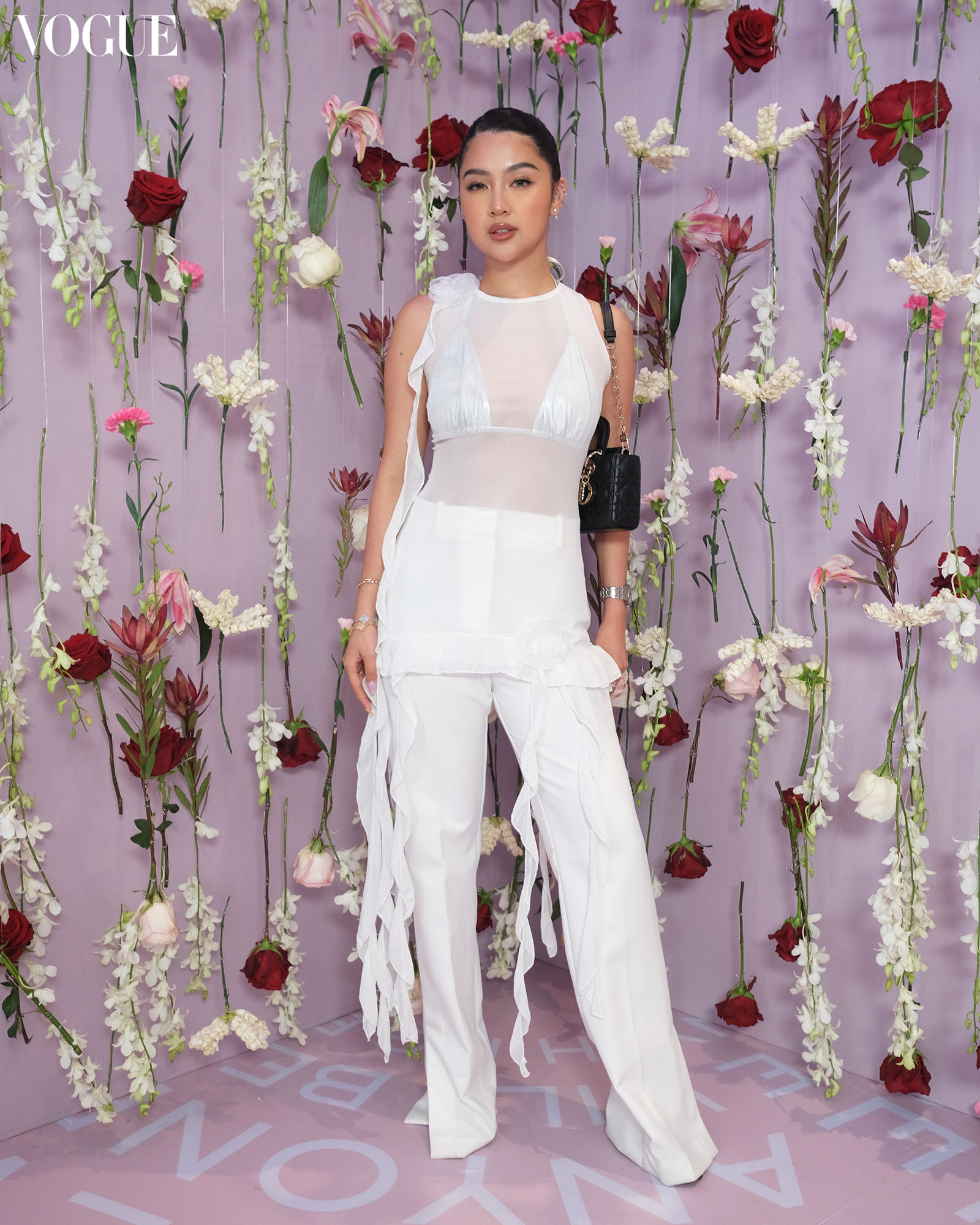 Rei Germar poses in front of a wall of floral stems at the Lancôme launch in the Philippines