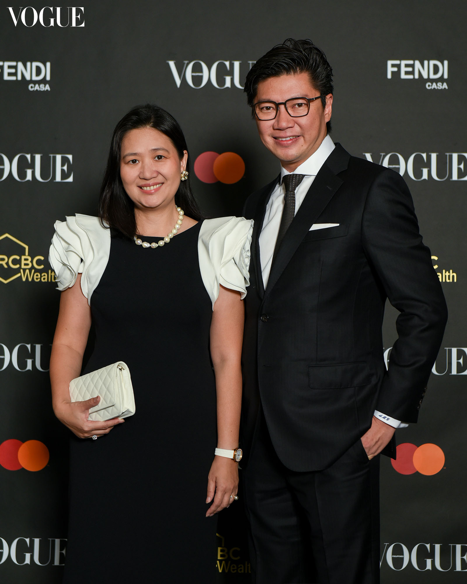 Dr Steve Mark Gan and Marilyn Gan posing at the photo wall at the Vogue Philippines Gala 2023