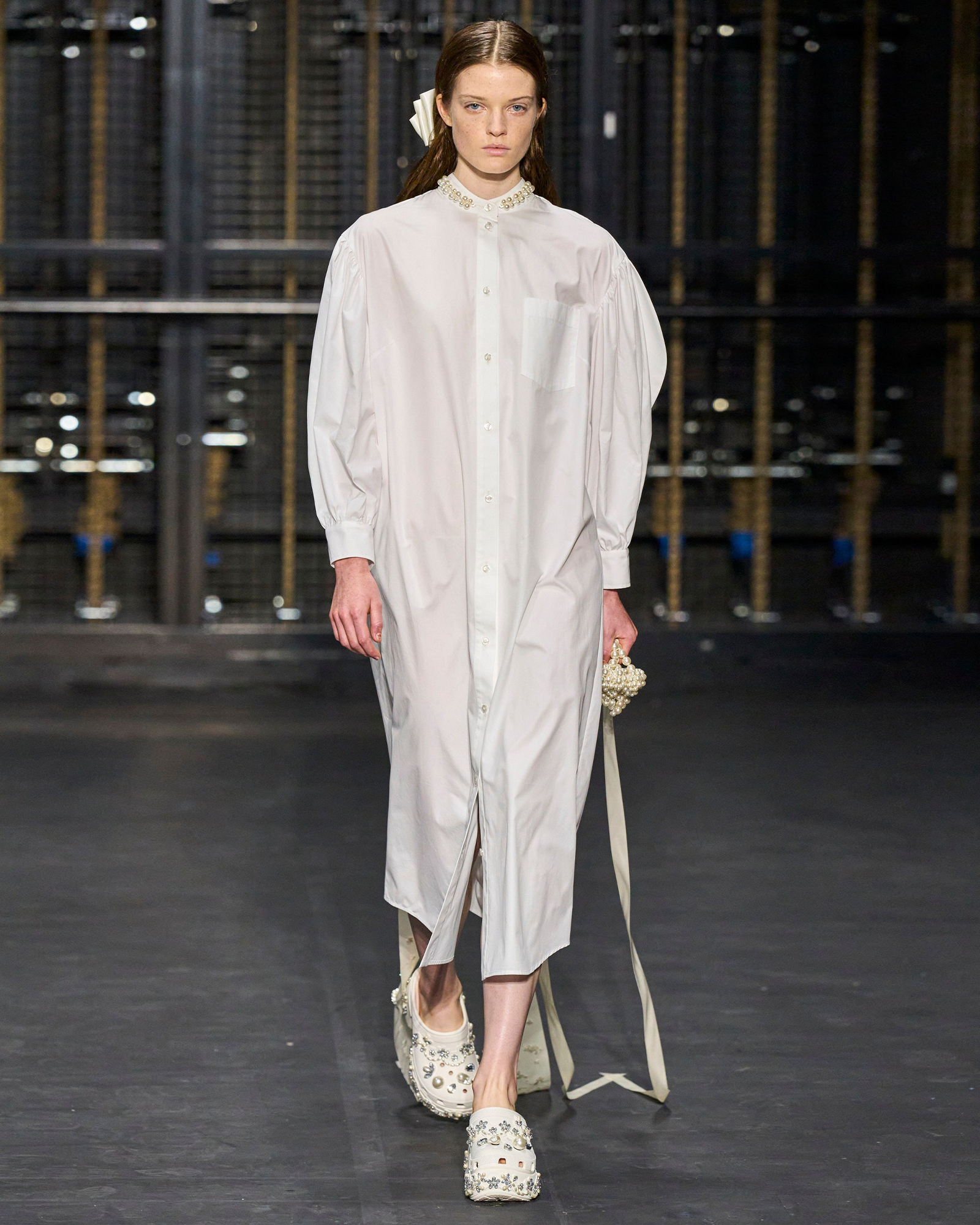 White dress and couture crocs by Simone Rocha.