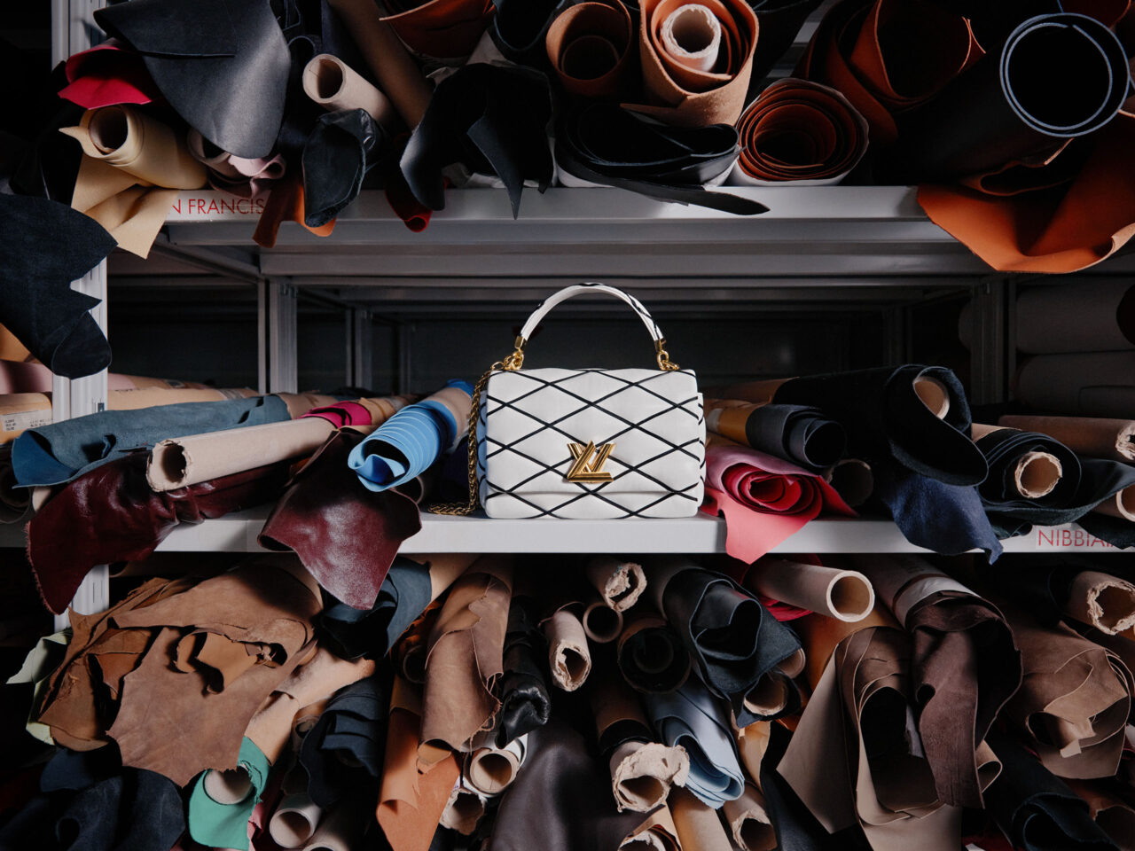 A white Louis Vuitton bag by fabric rolls