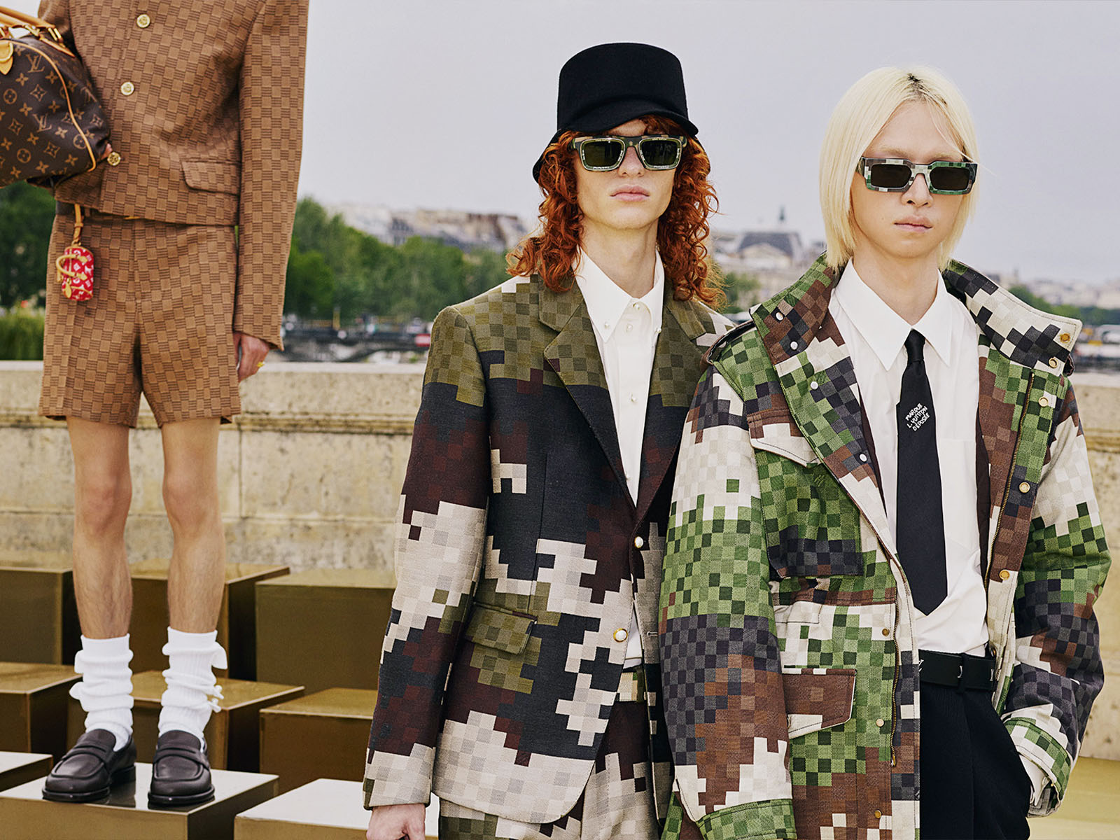 pharrell williams debuts first louis vuitton men's collection against a  checkered gold backdrop