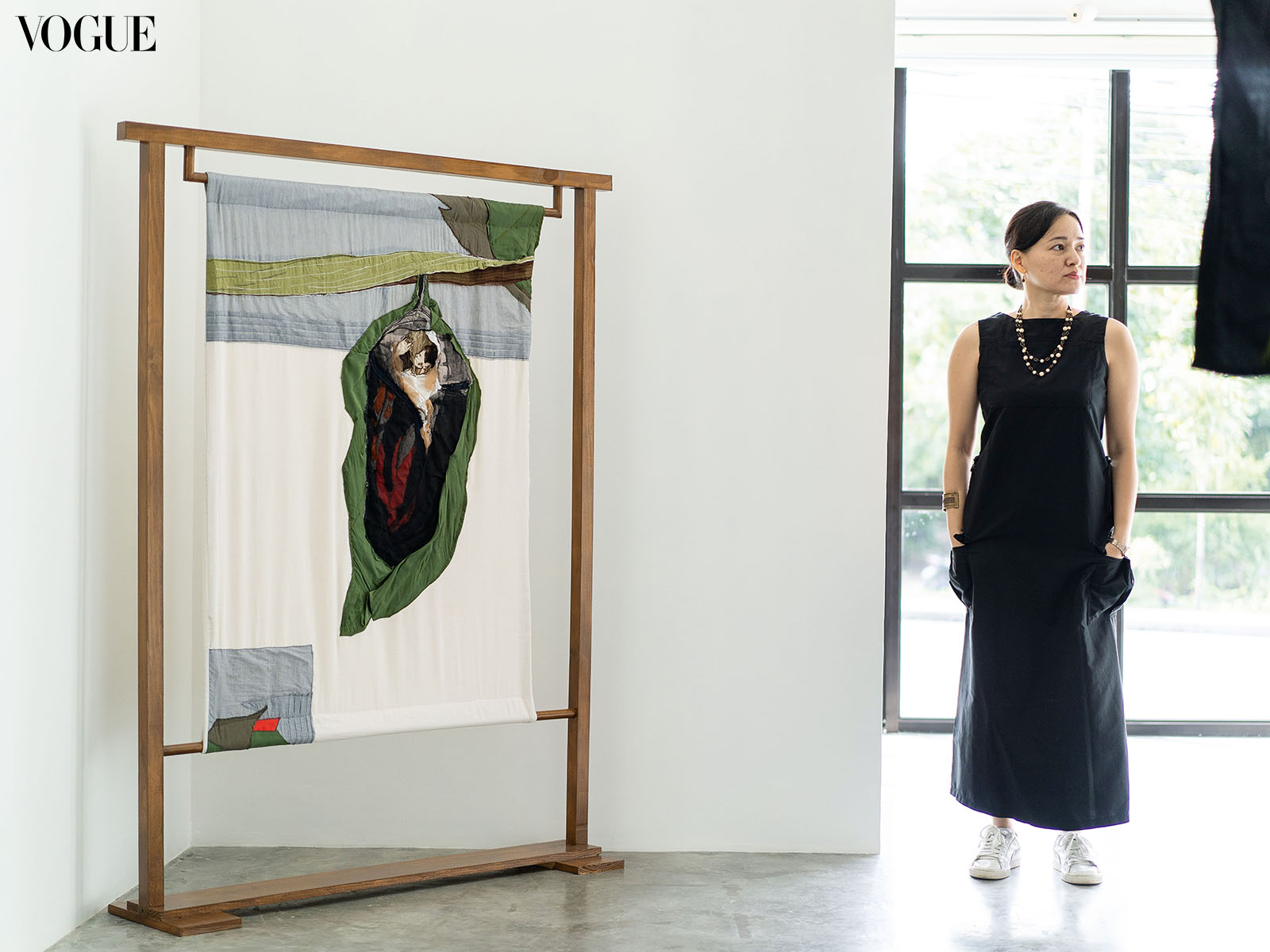 Woman next to a Dumaguete artwork.