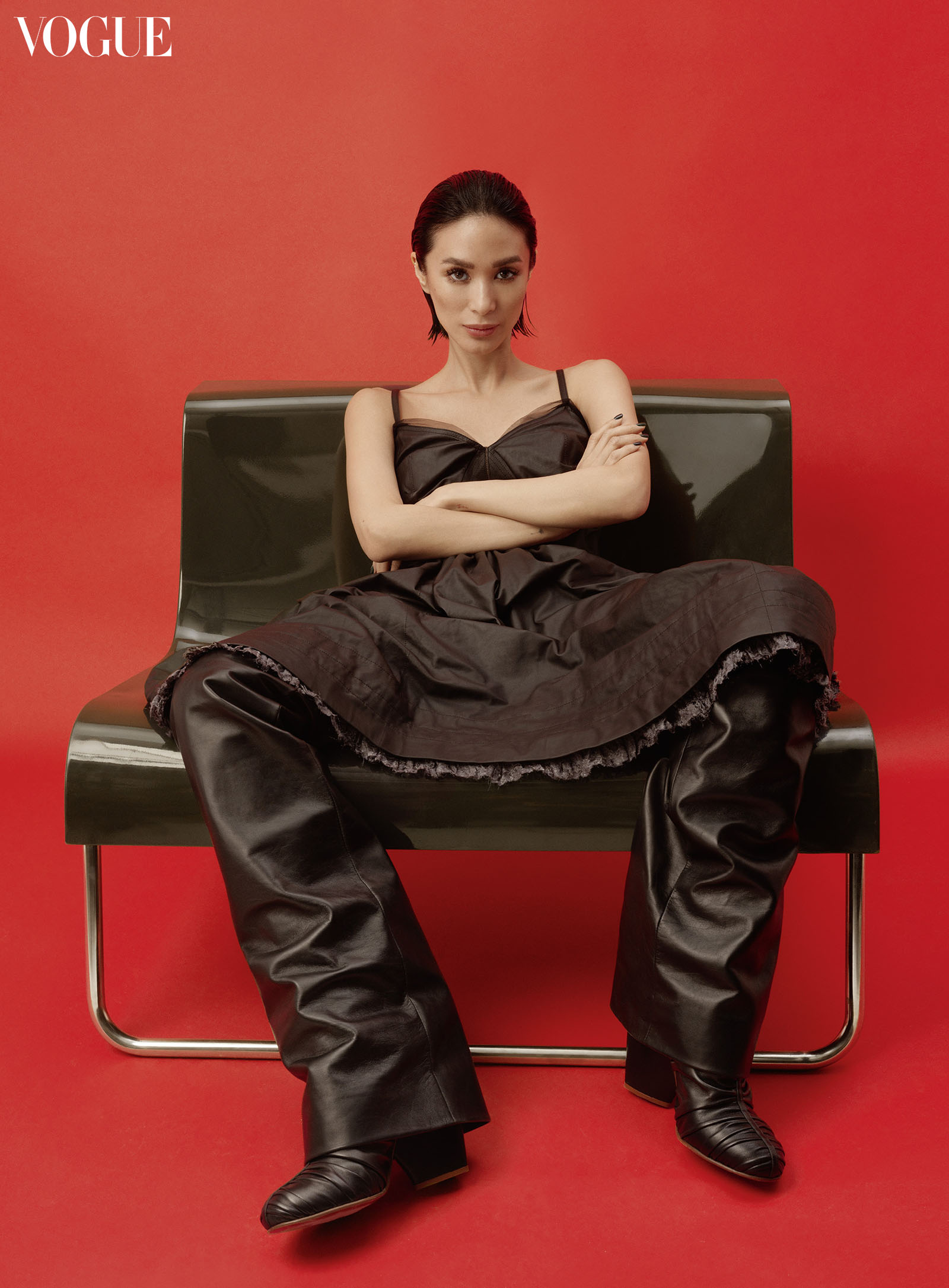 Heart Evangelista wearing a Louis Vuitton leather camisole dress, low-slung leather trousers, and Olympia high boots.