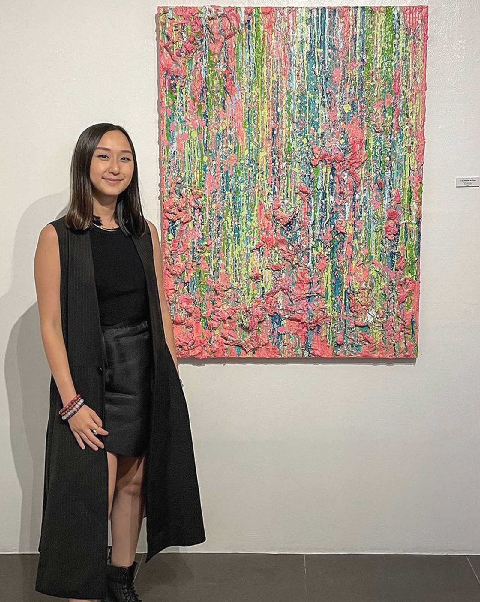 Rosenthal Tee posing beside her art piece